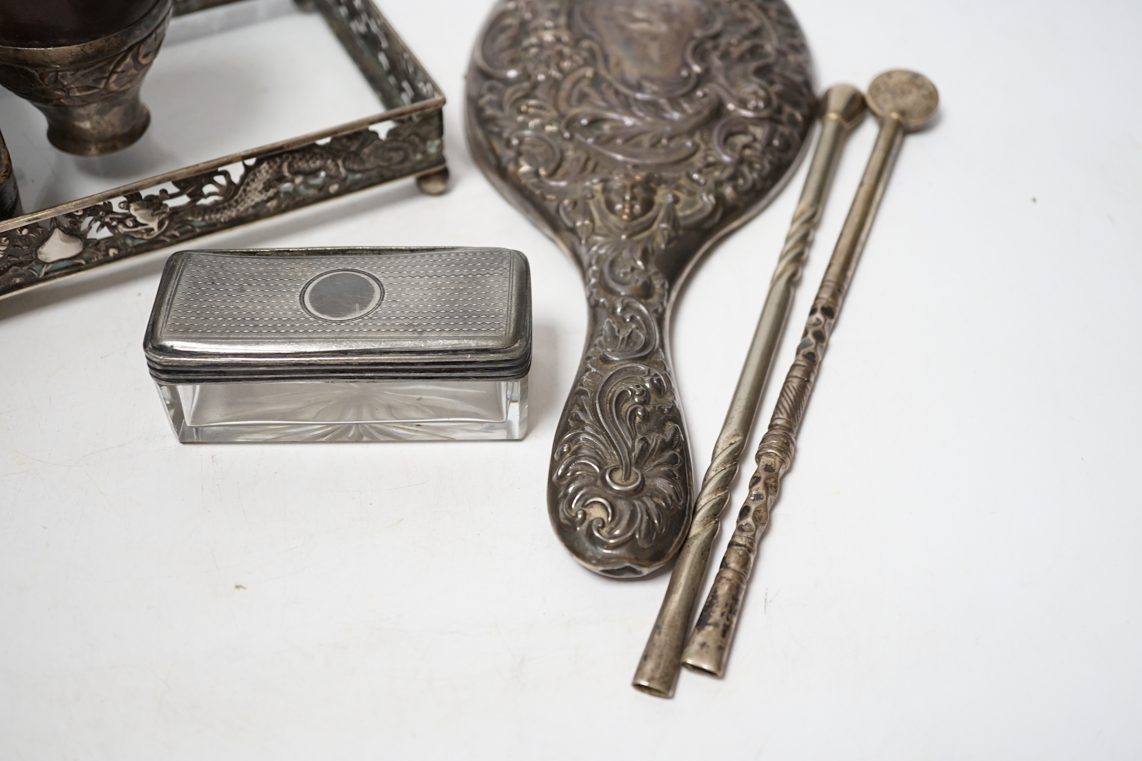 An Edwardian silver mounted travelling pocket watch case, Birmingham, 1905, with nickel cased pocket watch, together with a repousse silver mounted hand mirror, a Chinese white metal mounted glass dressing table tray and